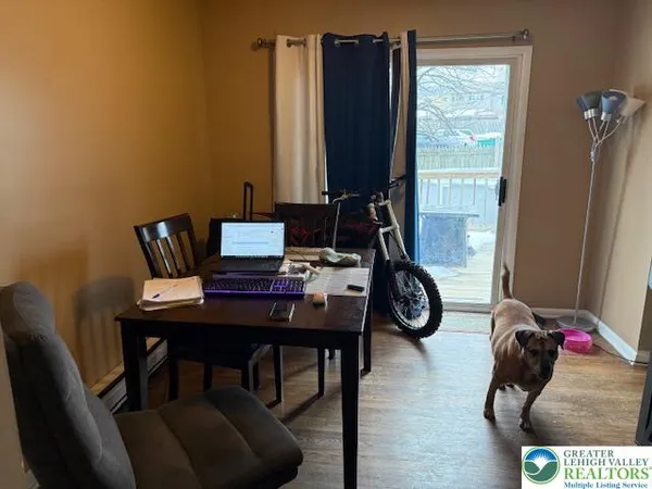a view of a workspace with furniture and a window