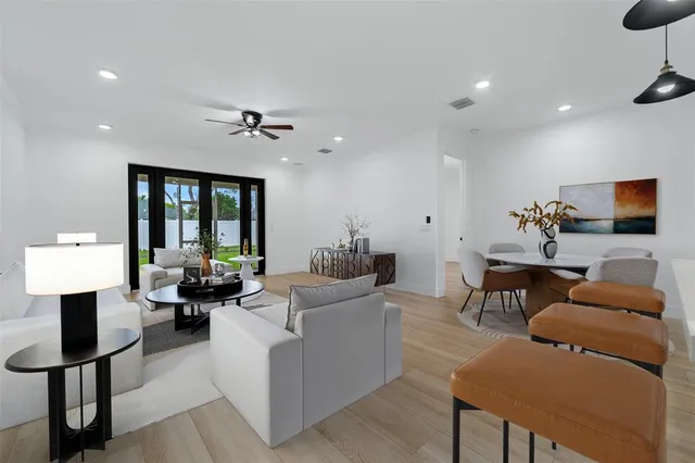 a living room with furniture a lamp and a chandelier