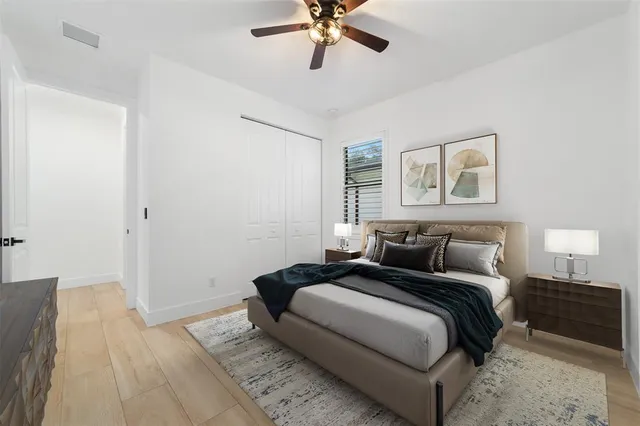 a bedroom with a large bed and a chandelier