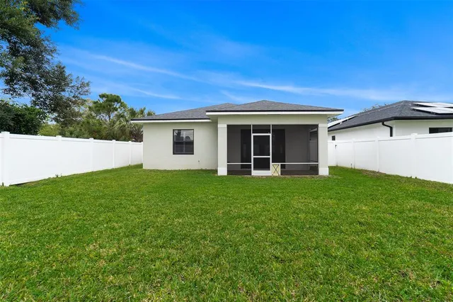 a view of a house with a backyard