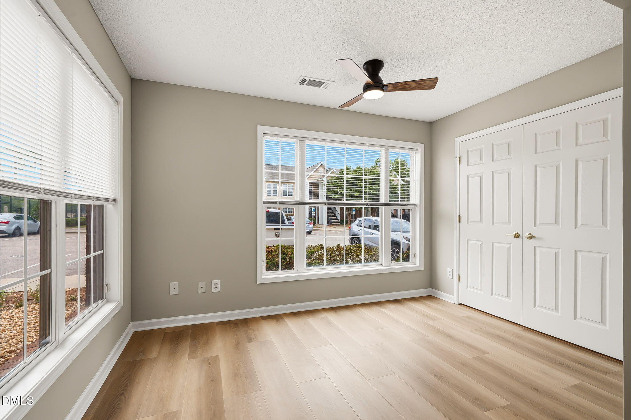 2501 Huntscroft Lane, Unit 100 Raleigh, NC 27617 - Photo 19 of 31 a view of an empty room with a window and wooden floor