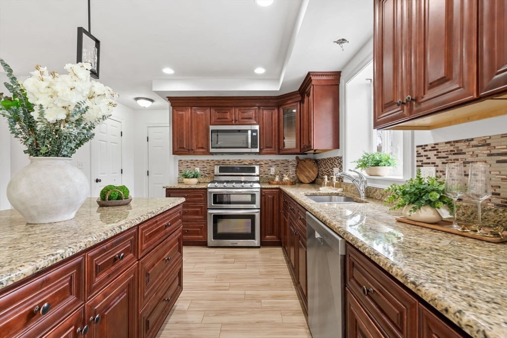 30 Neponset Street Walpole, MA 02071 - Photo 22 of 41 a kitchen with stainless steel appliances granite countertop a stove a sink and a wooden cabinets