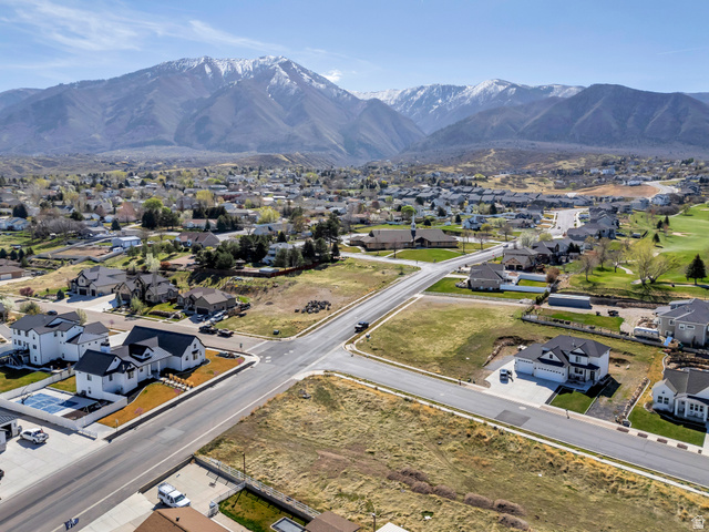 296 West Olympic Lane, Unit 2 Elk Ridge, UT 84651 - Photo 12 of 14 Aerial perspective of suburban area featuring a mountainous background