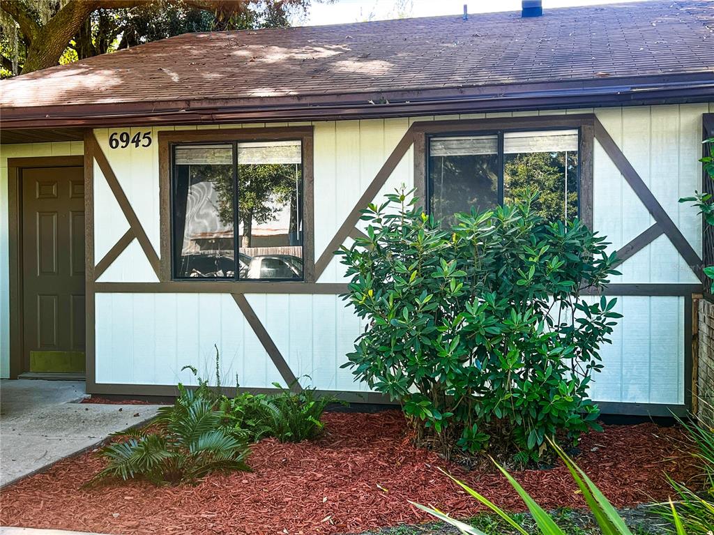 a front view of a house with garden