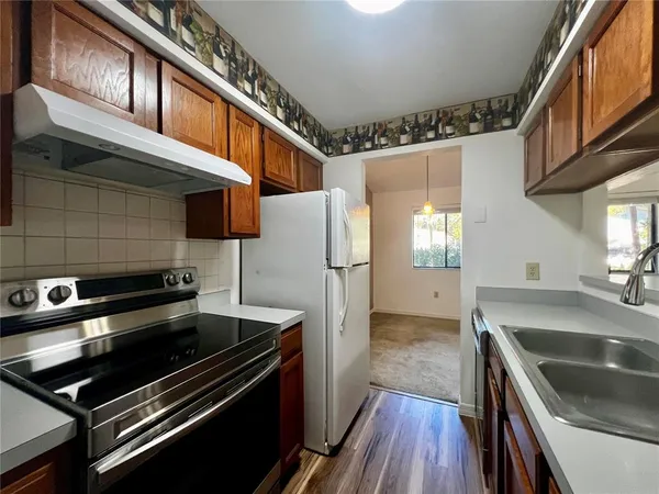 a kitchen with stainless steel appliances granite countertop a sink and a stove