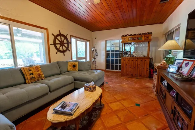 a living room with furniture a couch and a window