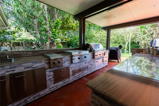 a kitchen with stainless steel appliances granite countertop a stove and a wooden floor