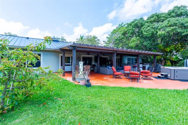 a view of a house with swimming pool and porch