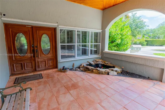 a bedroom with furniture and a large window
