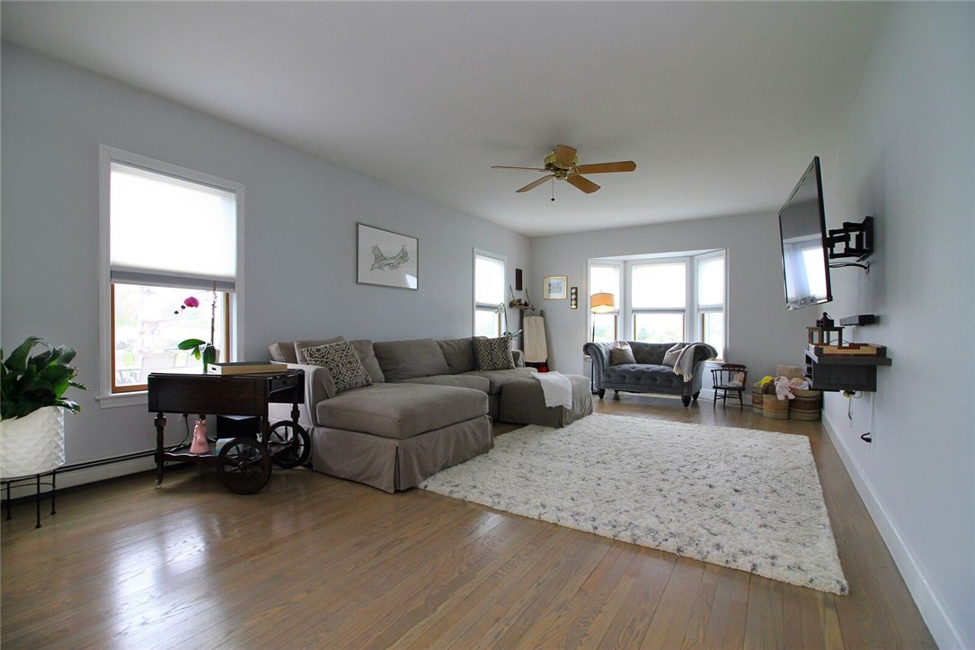 74 Sisson Pond Road Portsmouth, RI 02871 - Photo 13 of 39 Kitchen leads into spacious family room featuring beautifully refinished light gray hardwood floors throughout the first and second floors.