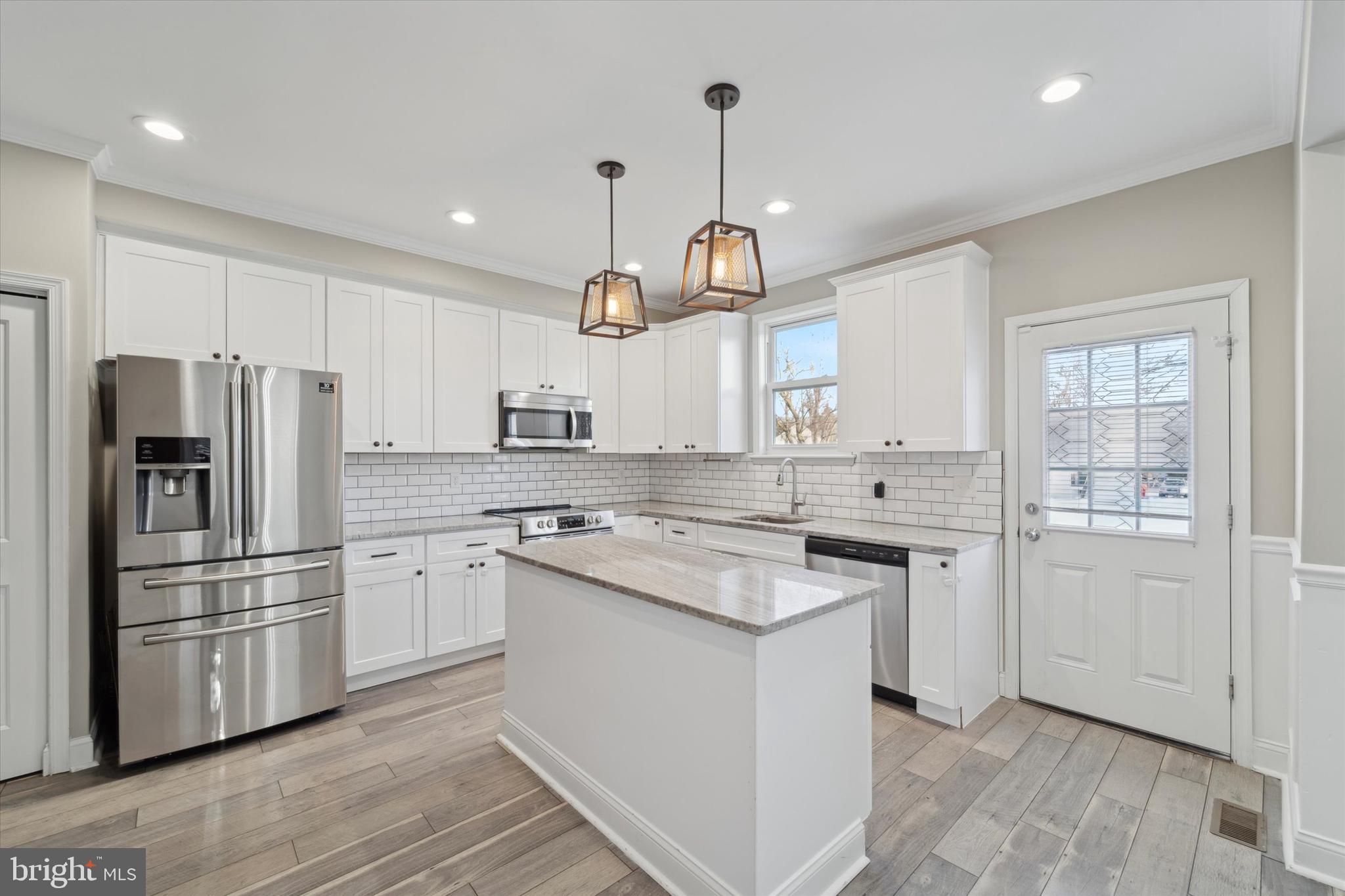 341 Date Street Warminster, PA 18974 - Photo 3 of 33 a kitchen with stainless steel appliances granite countertop a sink a stove a refrigerator and island with wooden floor