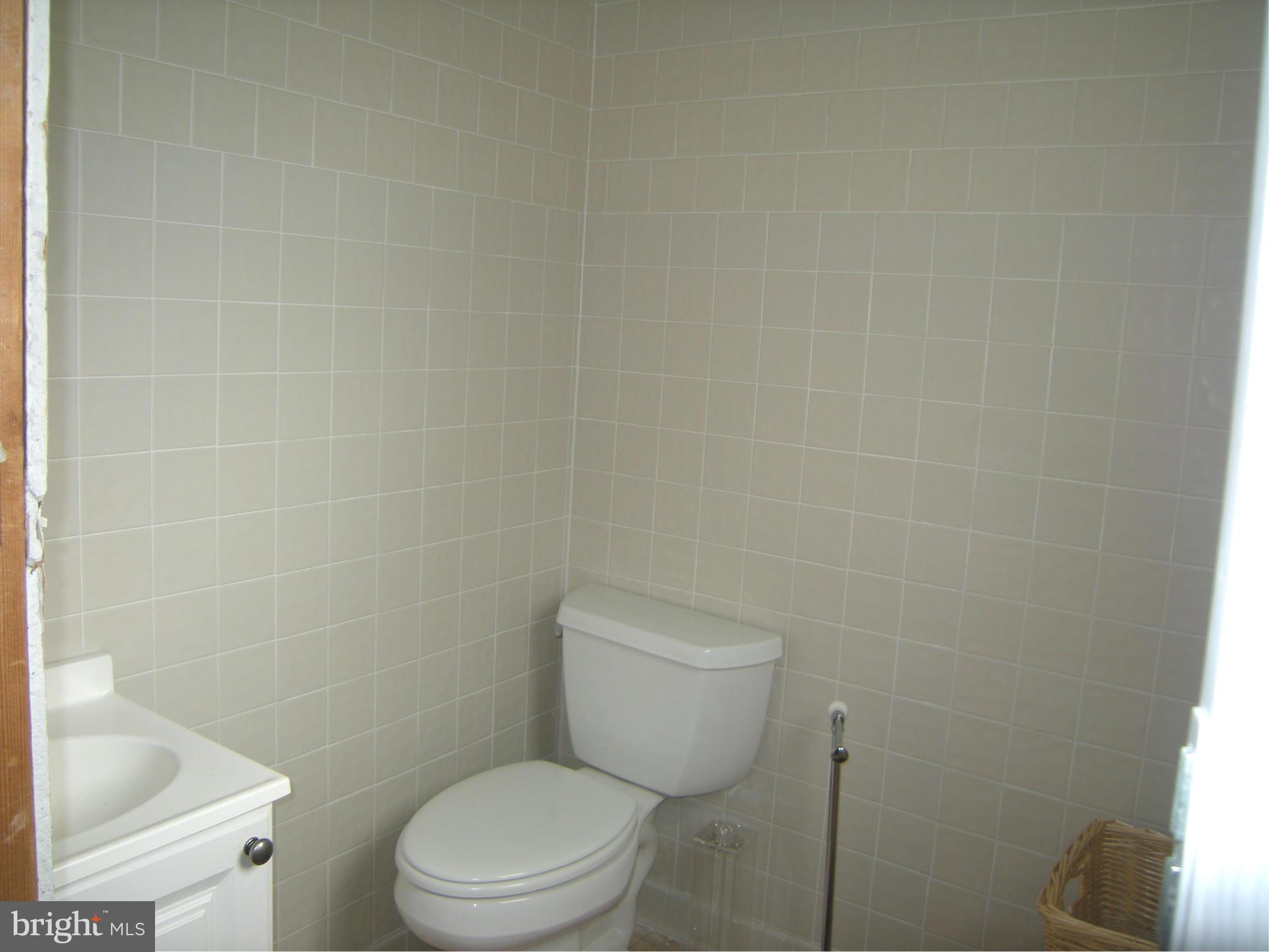 3067 Perch Drive Riva, MD 21140 - Photo 16 of 28 a white toilet sitting next to a white sink and vanity