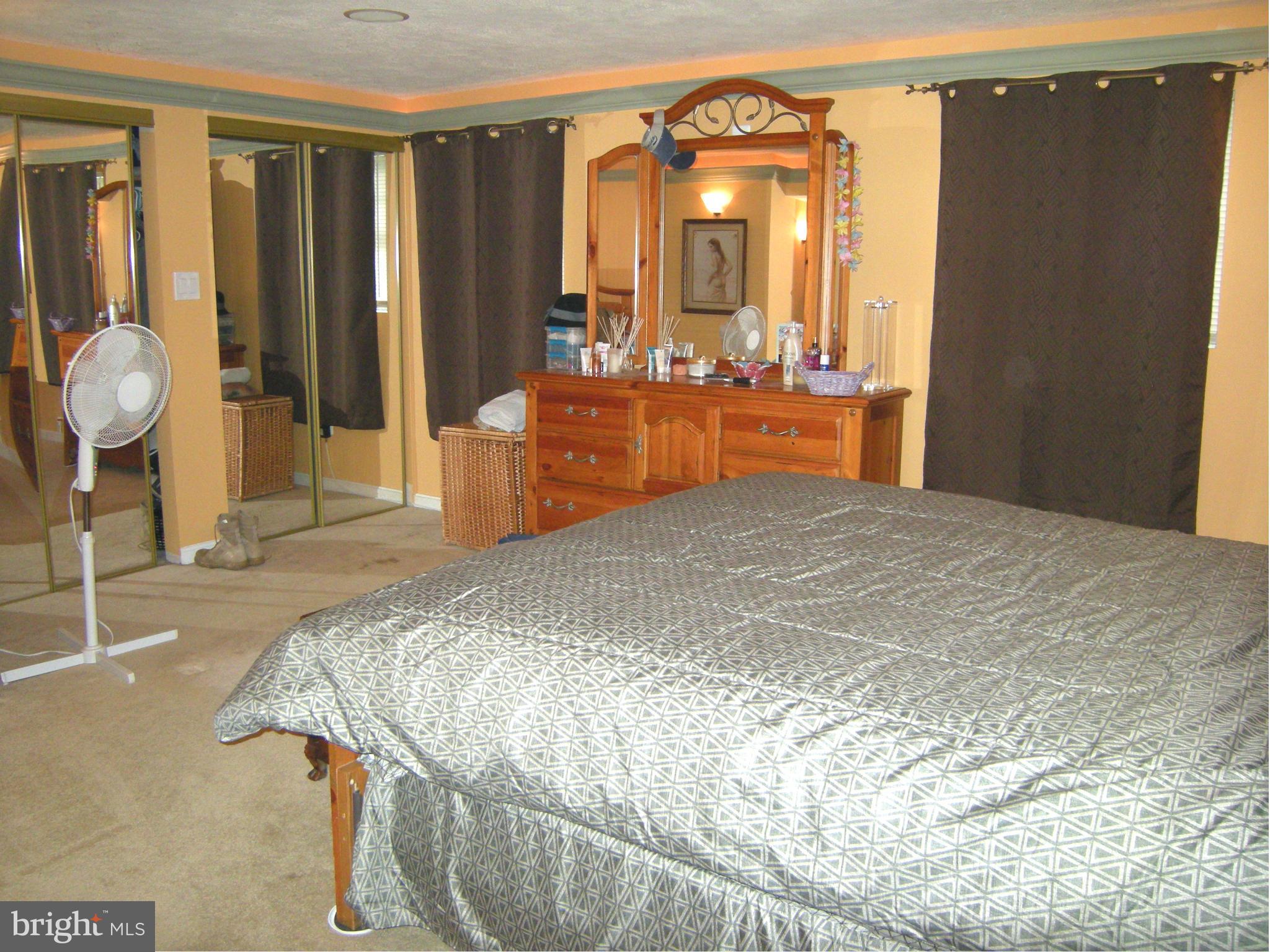3067 Perch Drive Riva, MD 21140 - Photo 22 of 28 a bedroom with a bed and dresser with mirror