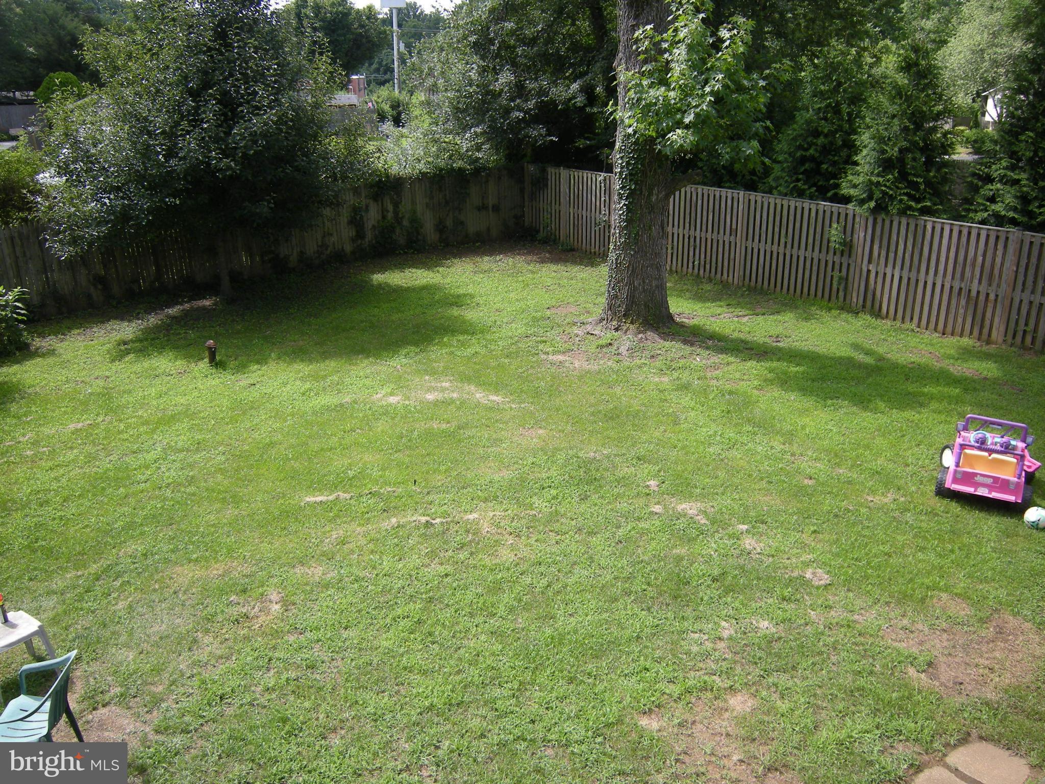 3067 Perch Drive Riva, MD 21140 - Photo 27 of 28 a backyard of a house with lots of plants and tree