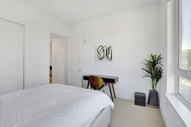 a bedroom with a bed and a couch