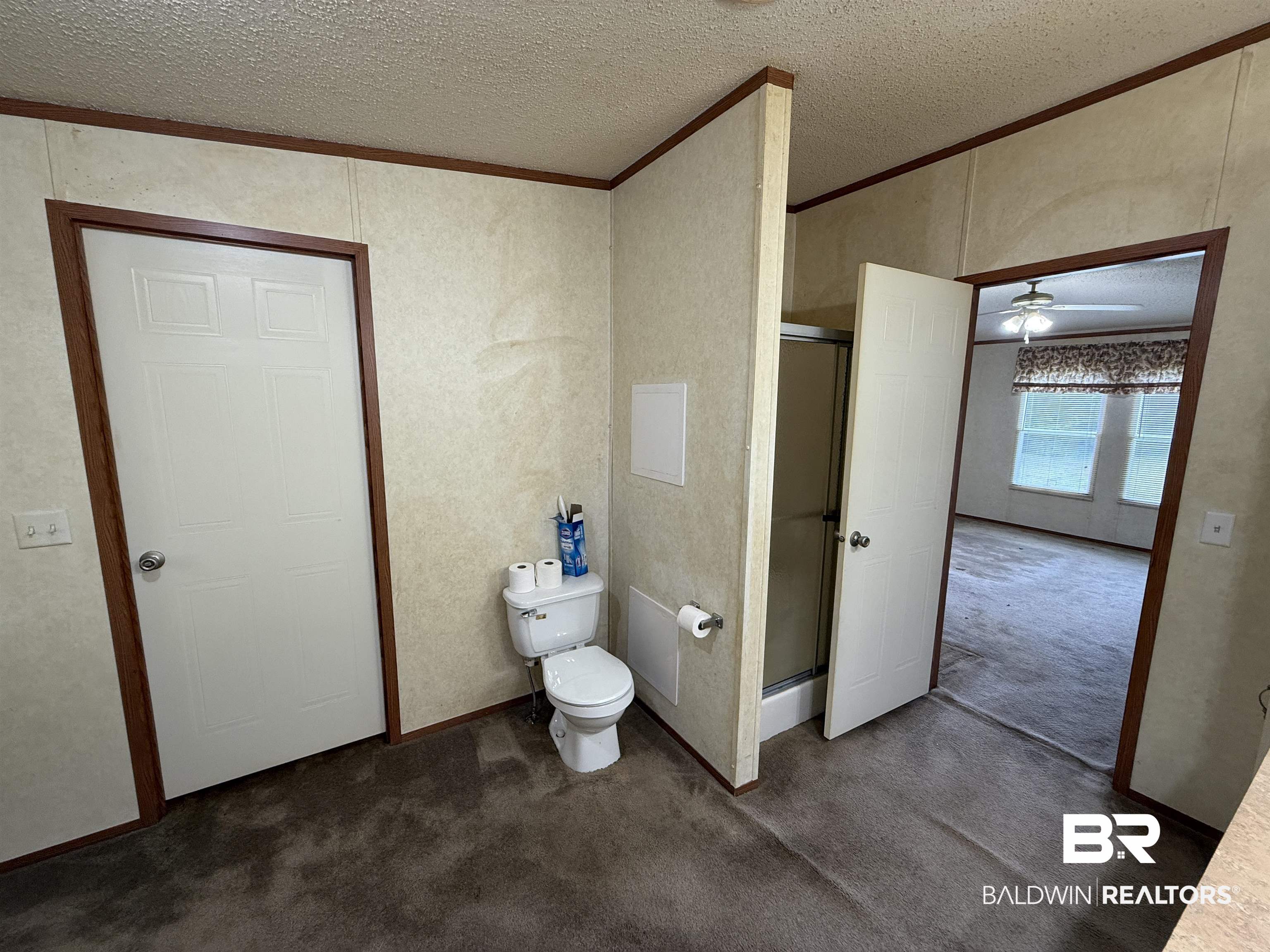 14402 County Road 55 Foley, AL 36535 - Photo 14 of 20 Bathroom with a shower with door, toilet, ornamental molding, a textured ceiling, and ceiling fan