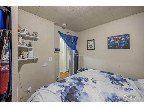 a bedroom with a bed and a wall painting