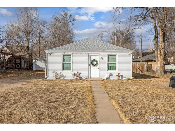 a view of a house with a yard covered in snow