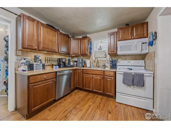 a kitchen with stainless steel appliances granite countertop a stove sink and cabinets