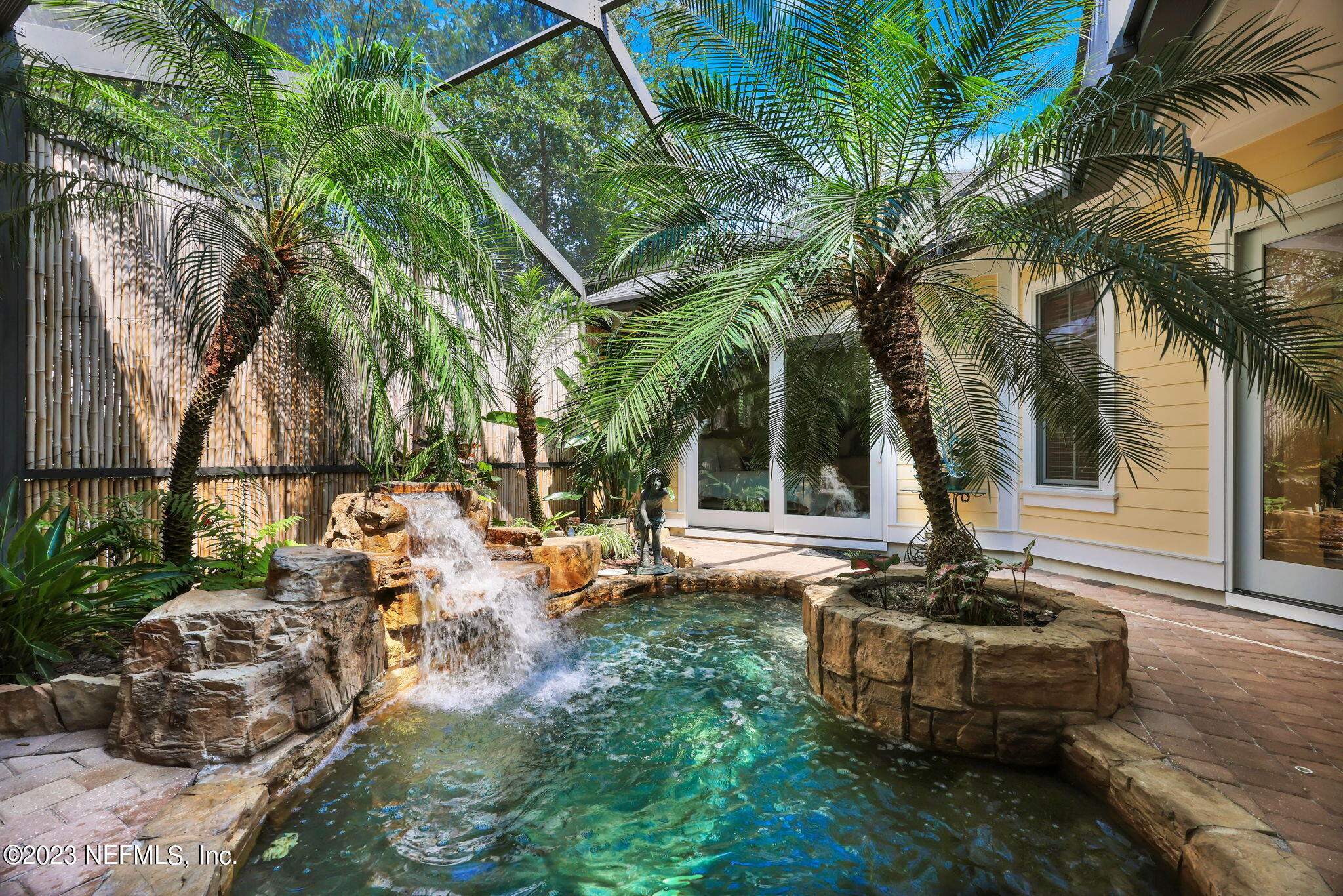 a view of a house with backyard and sitting area