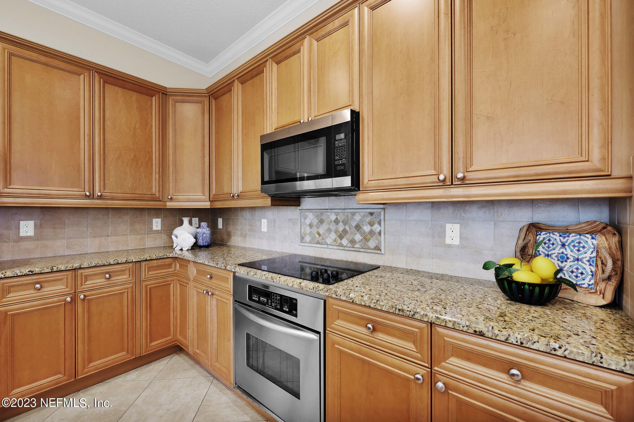 120 Istoria Drive St. Augustine, FL 32095 - Photo 29 of 90 a kitchen with stainless steel appliances granite countertop a sink a stove and cabinets