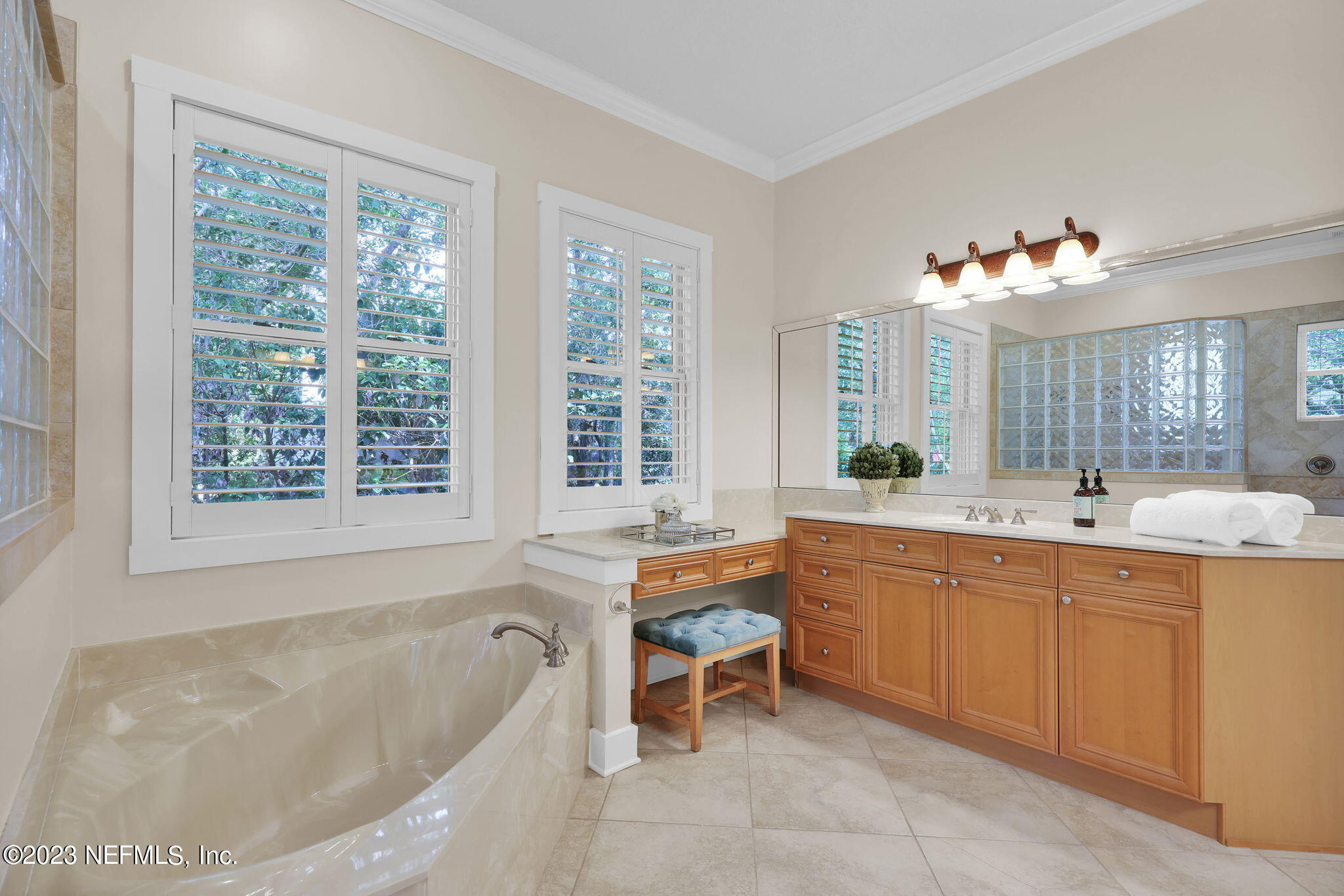 120 Istoria Drive St. Augustine, FL 32095 - Photo 37 of 90 a large spacious bathroom with a tub double sink window and mirror