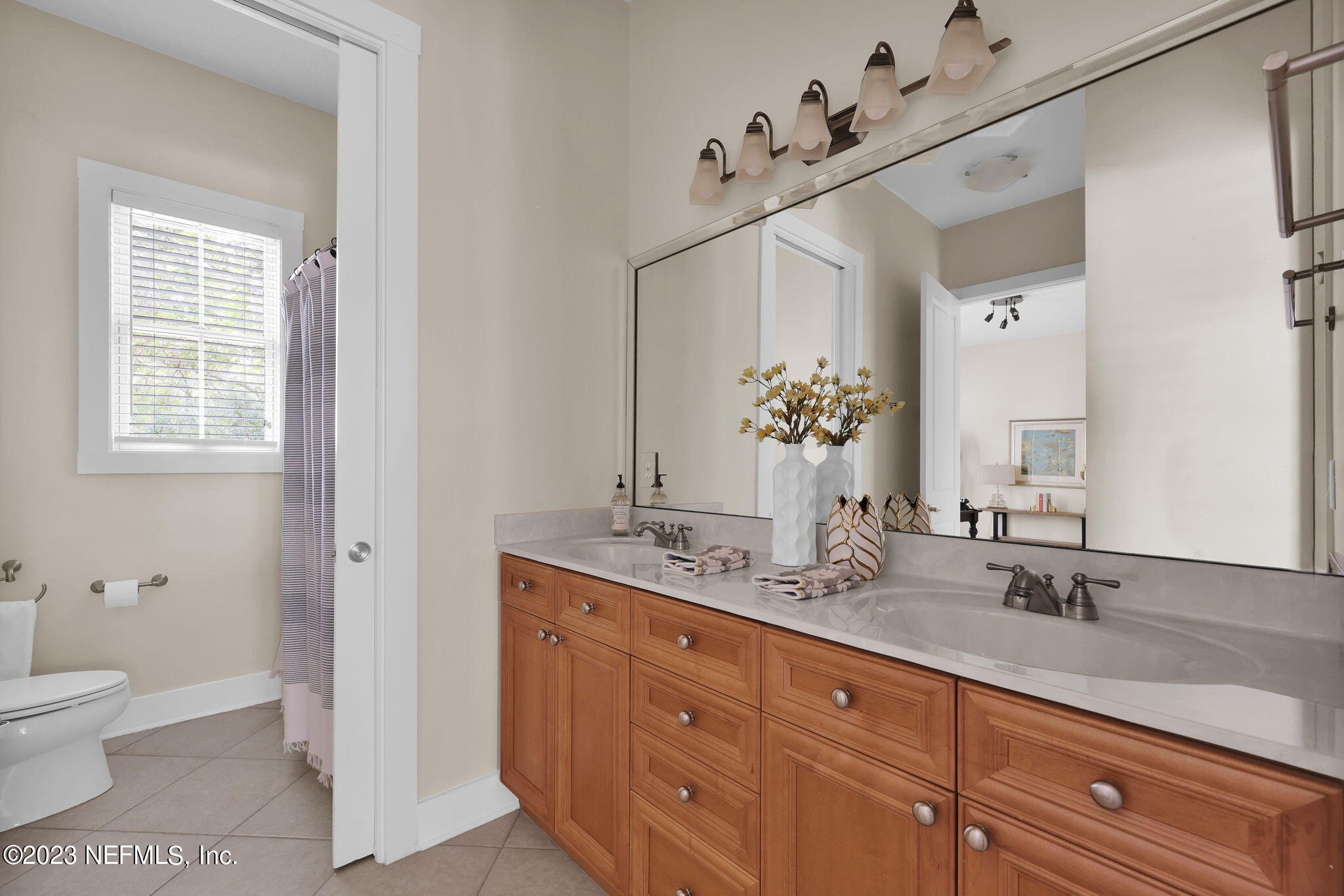 120 Istoria Drive St. Augustine, FL 32095 - Photo 44 of 90 a spacious bathroom with a granite countertop double vanity sink a mirror and a toilet