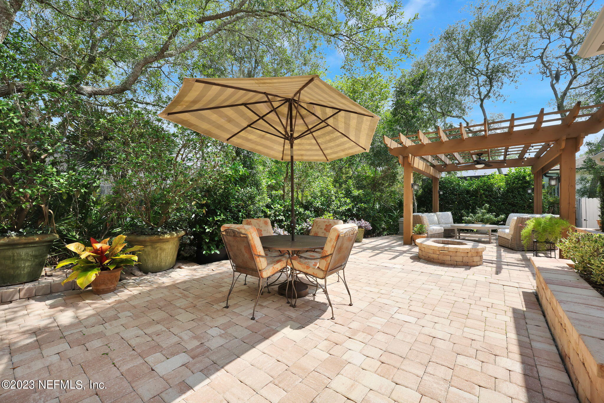120 Istoria Drive St. Augustine, FL 32095 - Photo 53 of 90 a view of a patio with a table and chairs under an umbrella