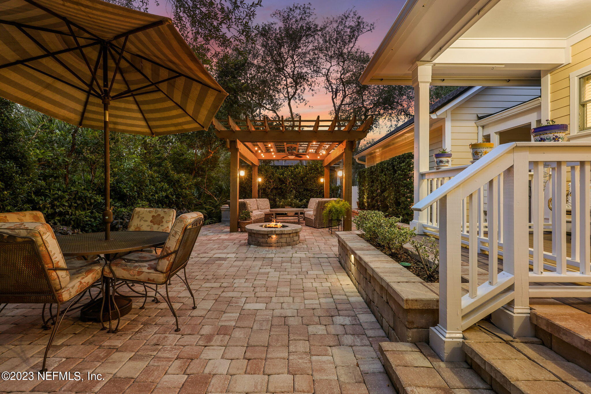 120 Istoria Drive St. Augustine, FL 32095 - Photo 61 of 90 a view of a patio with table and chairs under an umbrella