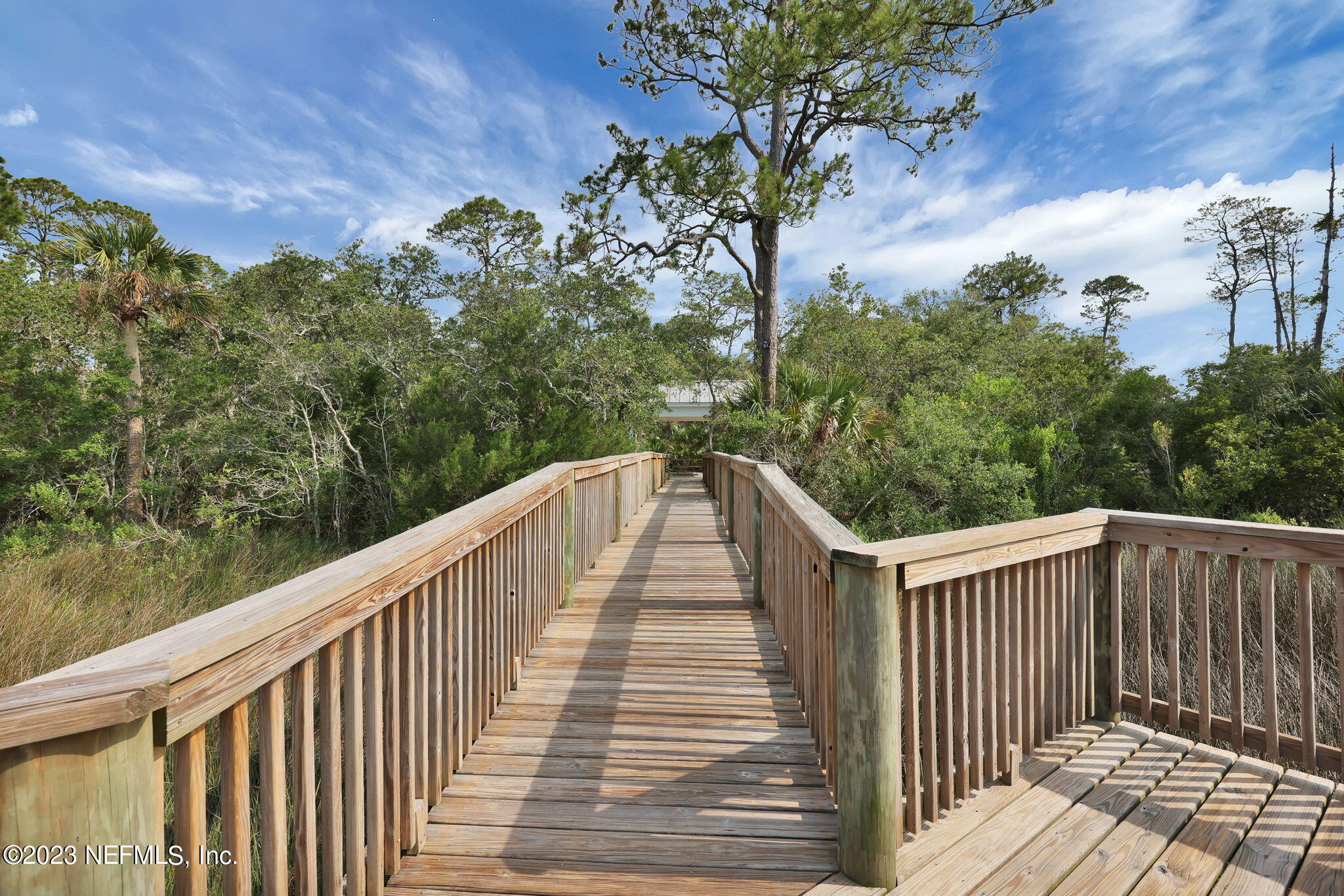 120 Istoria Drive St. Augustine, FL 32095 - Photo 76 of 90 a balcony with wooden floor and trees in the back