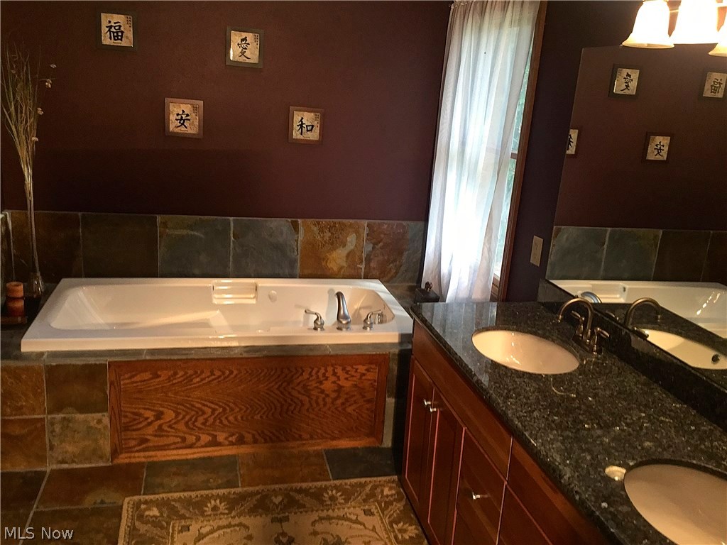 7229 Red Brush Road Ravenna, OH 44266 - Photo 15 of 22 Homeowner Master Bath With Jetted Tub/Double Vanity Sinks W Granite Counter Top. Double Closets And
Shower. Slate Floor.