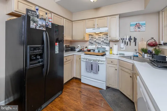 a kitchen with stainless steel appliances a refrigerator sink and cabinets