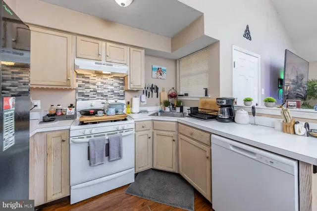 a kitchen with a white cabinets and white appliances