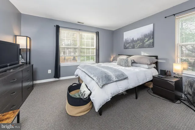 a bedroom with a bed and a television