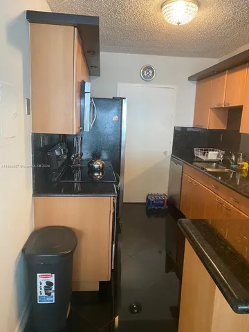 a kitchen with a table and chairs