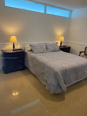 a bedroom with a bed and lamp