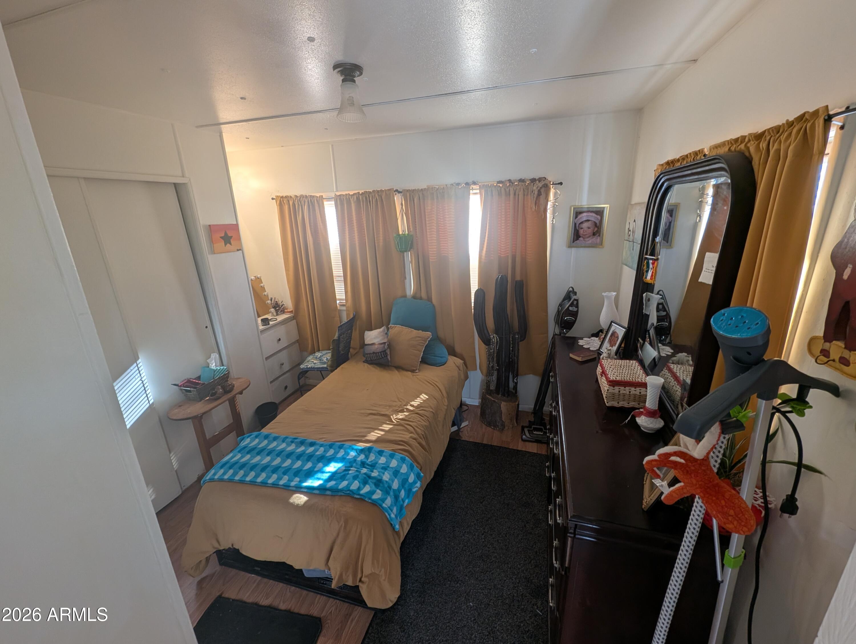 850 West Sieling Loop Bisbee, AZ 85603 - Photo 11 of 11 a bed room with a bed mirror and a desk