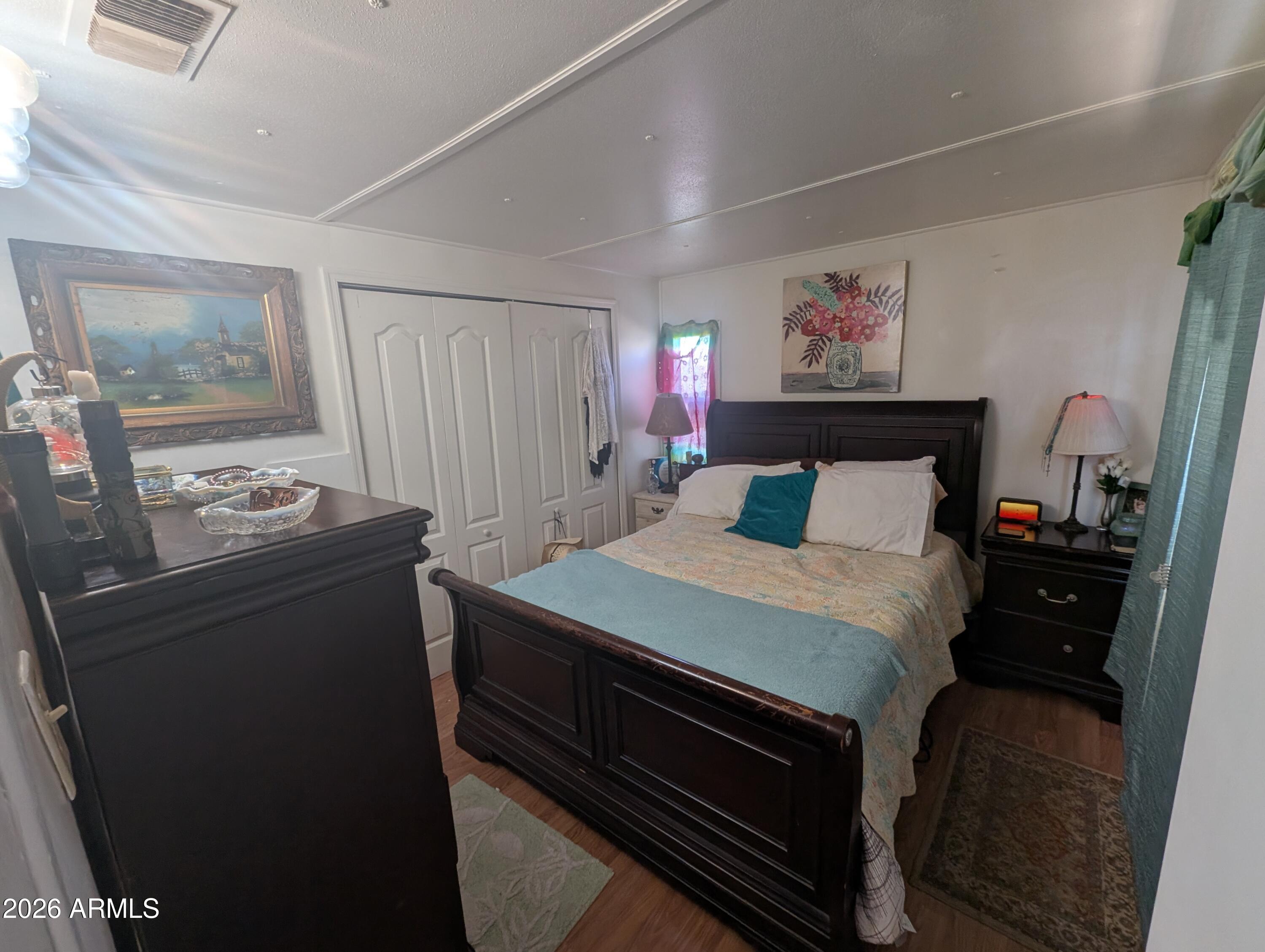 850 West Sieling Loop Bisbee, AZ 85603 - Photo 10 of 11 a bedroom with a bed and wooden floor