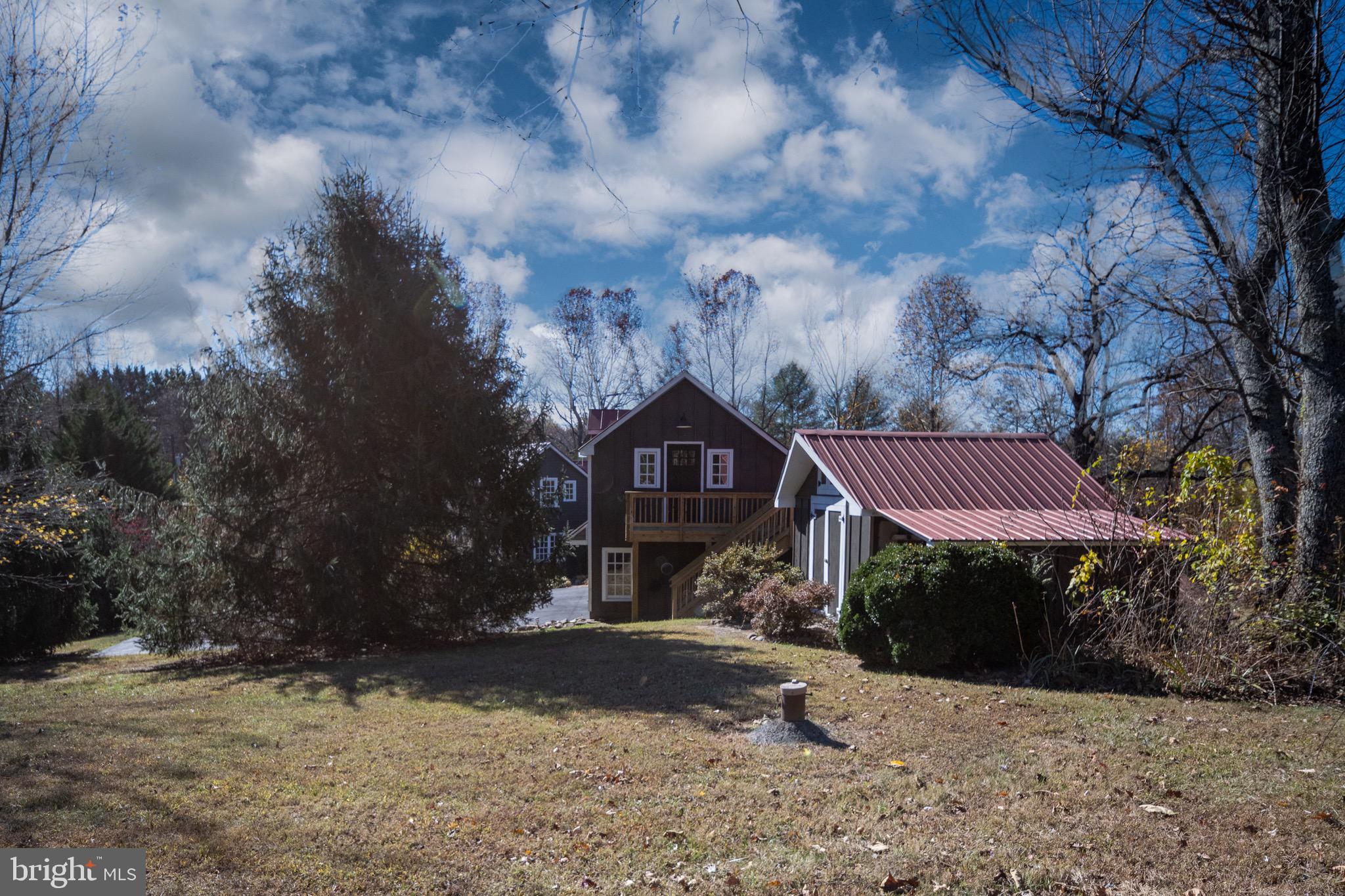 560 Richmond Road Amissville, VA 20106 - Photo 125 of 133 a view of a brick house next to a yard with large trees