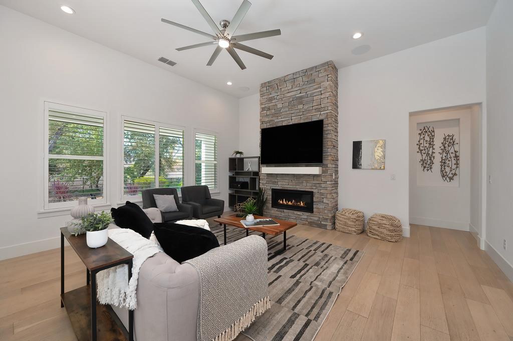 5855 Tree Swallow Circle Rocklin, CA 95677 - Photo 13 of 72 a living room with furniture a fireplace and a flat screen tv