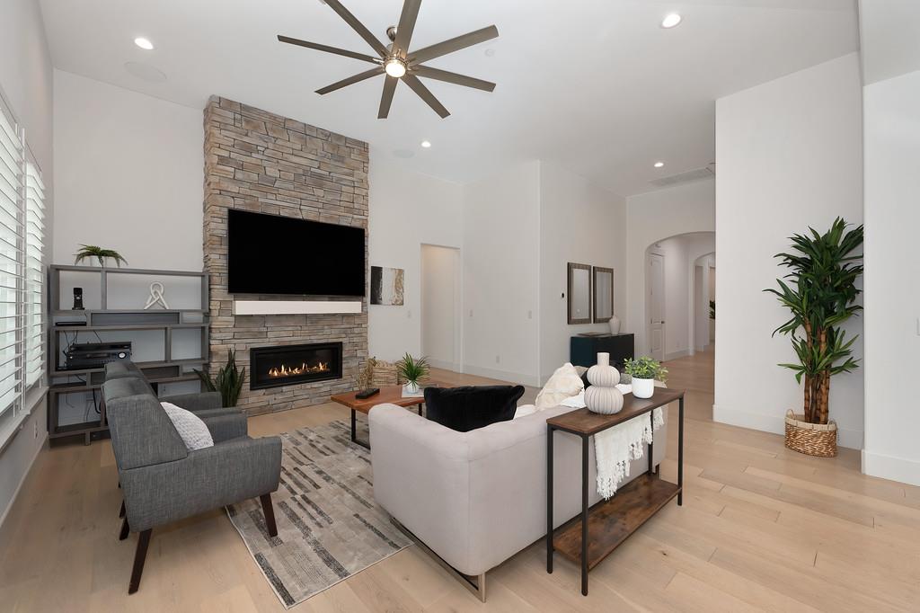 5855 Tree Swallow Circle Rocklin, CA 95677 - Photo 14 of 72 a living room with furniture a fireplace and a flat screen tv