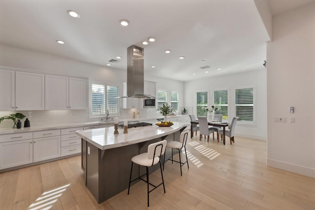 5855 Tree Swallow Circle Rocklin, CA 95677 - Photo 16 of 72 a kitchen with counter space dining table and chairs
