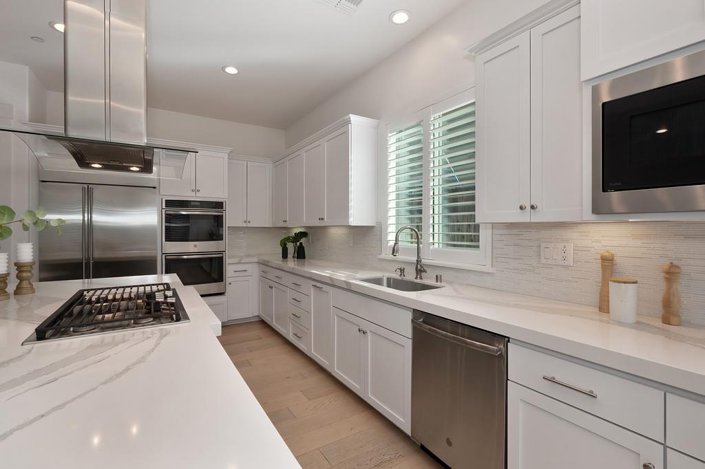 5855 Tree Swallow Circle Rocklin, CA 95677 - Photo 18 of 72 a kitchen with a sink stainless steel appliances and cabinets