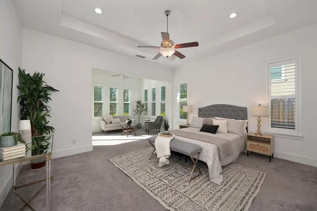 a bedroom with bed and a chandelier