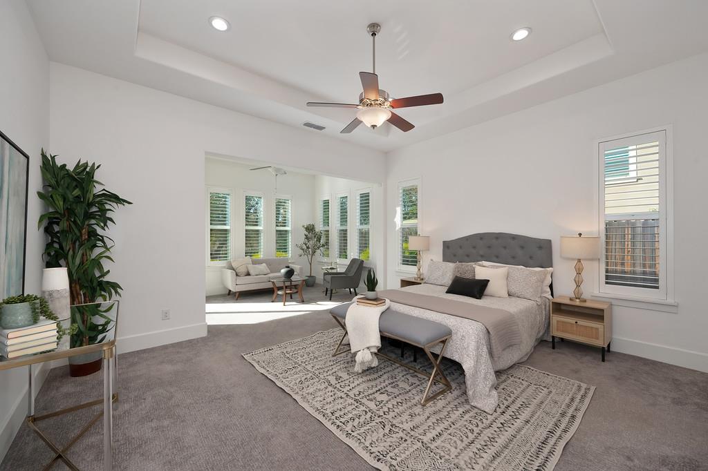 5855 Tree Swallow Circle Rocklin, CA 95677 - Photo 38 of 72 a bedroom with a large bed and a chandelier