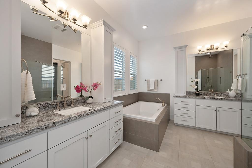 5855 Tree Swallow Circle Rocklin, CA 95677 - Photo 43 of 72 a bathroom with a granite countertop bathtub a double vanity sink a vanity and a