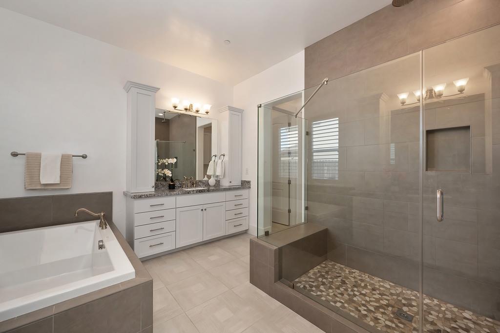 5855 Tree Swallow Circle Rocklin, CA 95677 - Photo 44 of 72 a bathroom with a tub a sink and a shower
