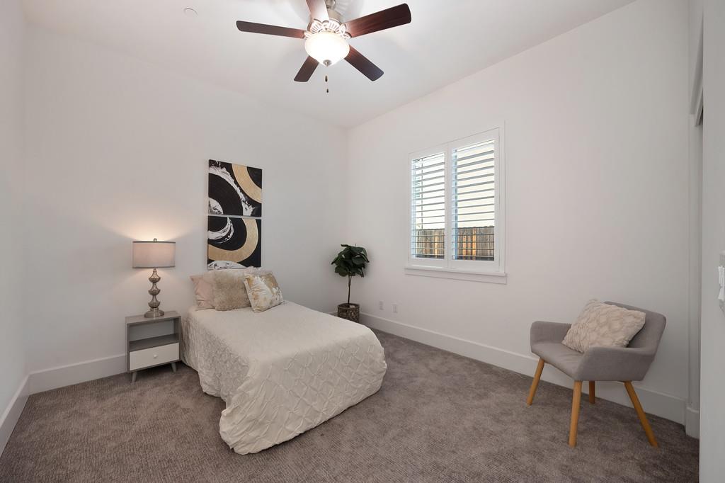 5855 Tree Swallow Circle Rocklin, CA 95677 - Photo 52 of 72 a bedroom with a bed and a chandelier