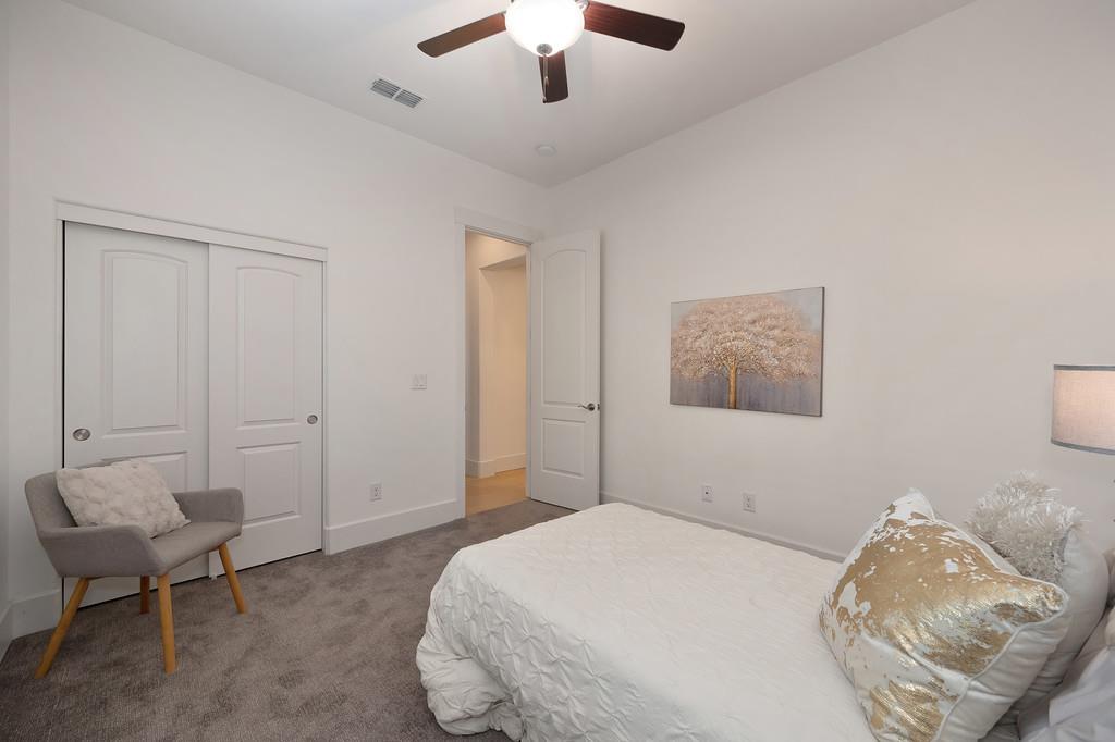 5855 Tree Swallow Circle Rocklin, CA 95677 - Photo 56 of 72 a bedroom with bed and a chandelier