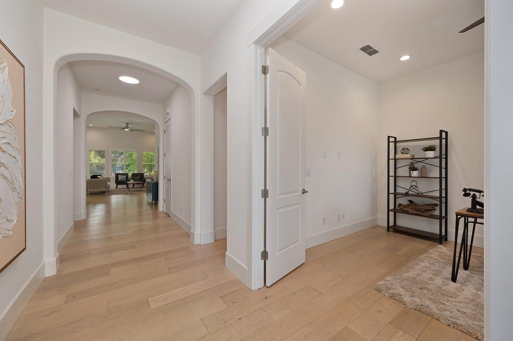 5855 Tree Swallow Circle Rocklin, CA 95677 - Photo 8 of 72 a view of a hallway with wooden floor and furniture